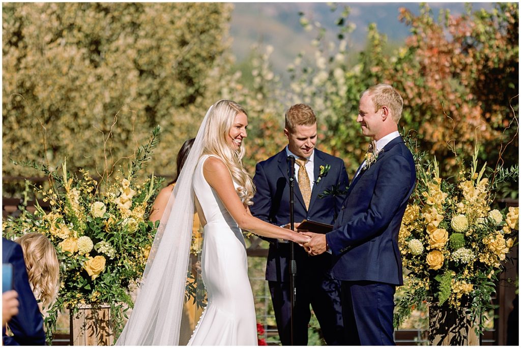 Bride and groom during ceremony at Larkspur Vail.  Floral decor by CVB Studio.