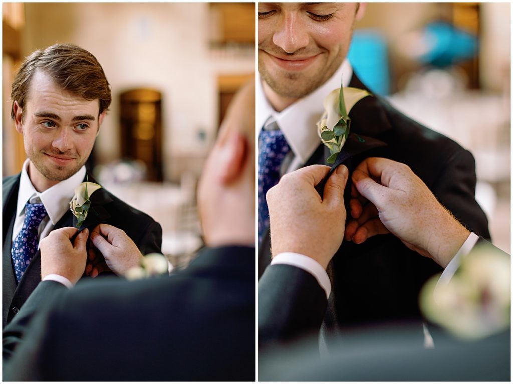 Groom putting on suit from Men's Wearhouse at Della Terra Mountain Chateau in Estes Park.