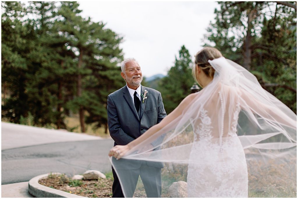 Father first look of bride at Della Terra Mountain Chateau in Estes Park.