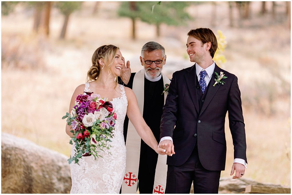 Wedding at Della Terra Mountain Chateau in Estes Park.  Bride wearing wedding dress designed by Martina Liana from Volle's Bridal & Boutique.  Groom Wearing suit from Men's Wearhouse.  Bride holding bouquet from The Perfect Petal.
