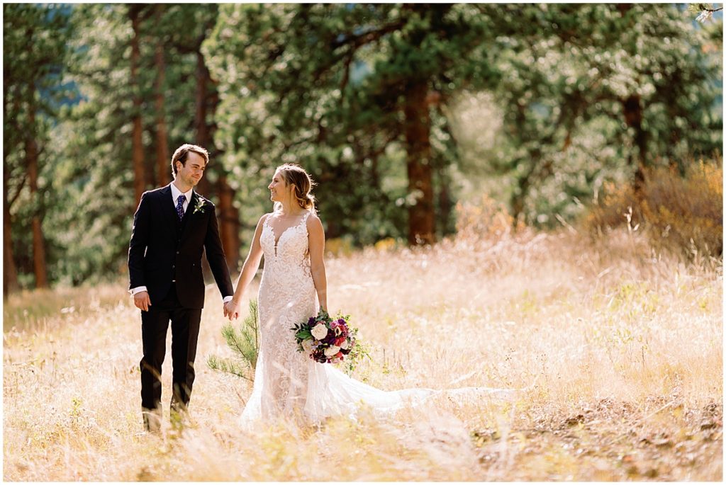 Wedding at Della Terra Mountain Chateau in Estes Park.  Bride wearing wedding dress designed by Martina Liana from Volle's Bridal & Boutique.  Groom Wearing suit from Men's Wearhouse.  Bride holding bouquet from The Perfect Petal.
