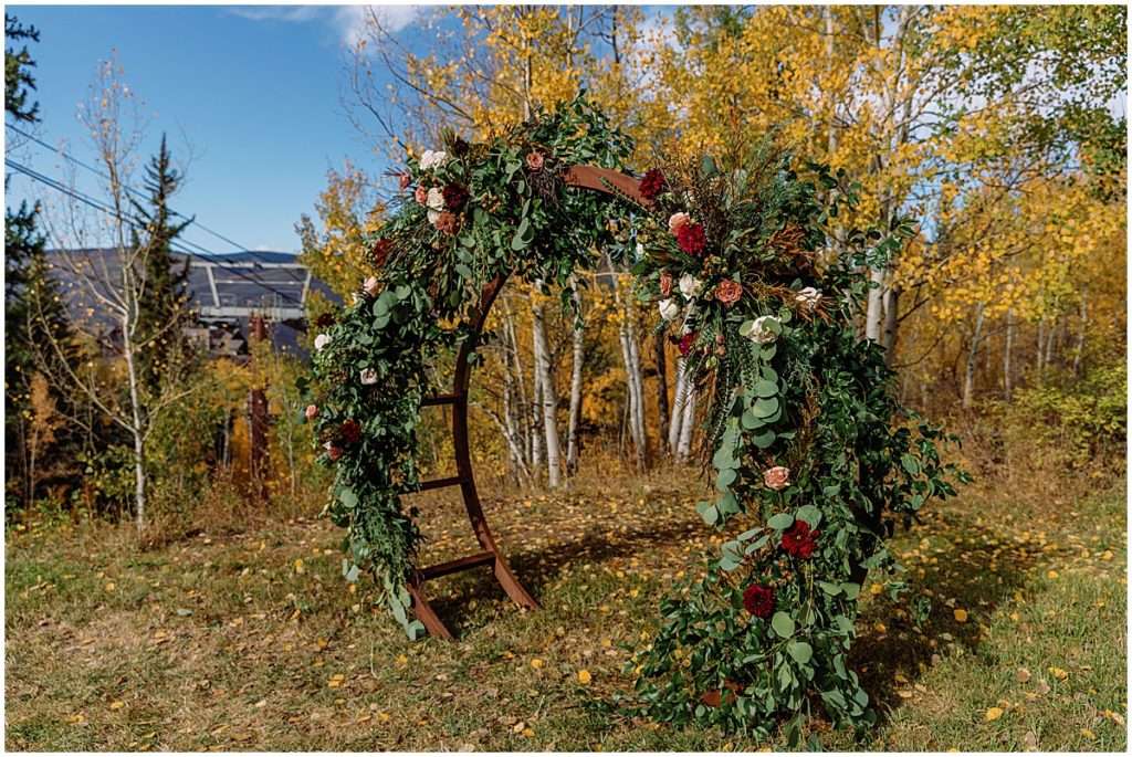 Floral arch designed by Bloom Flower Shop for wedding at Anderson's Cabin in Beaver Creek.