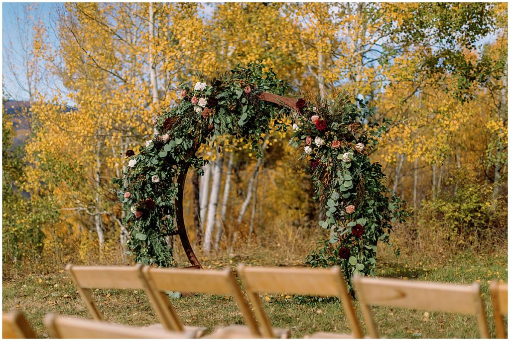 Floral arch designed by Bloom Flower Shop for wedding at Anderson's Cabin in Beaver Creek.