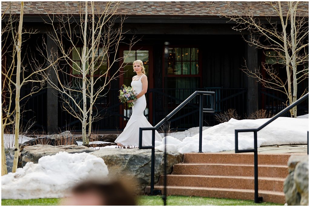 Bride walking down isle for wedding outside at Devil's Thumb Ranch.  Bride is holding bouquet designed by The Stalk Market.