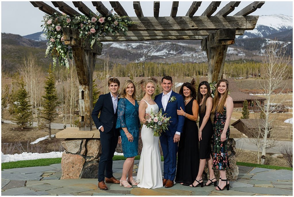 Bride and groom with their family after the ceremony at Devil's Thumb Ranch