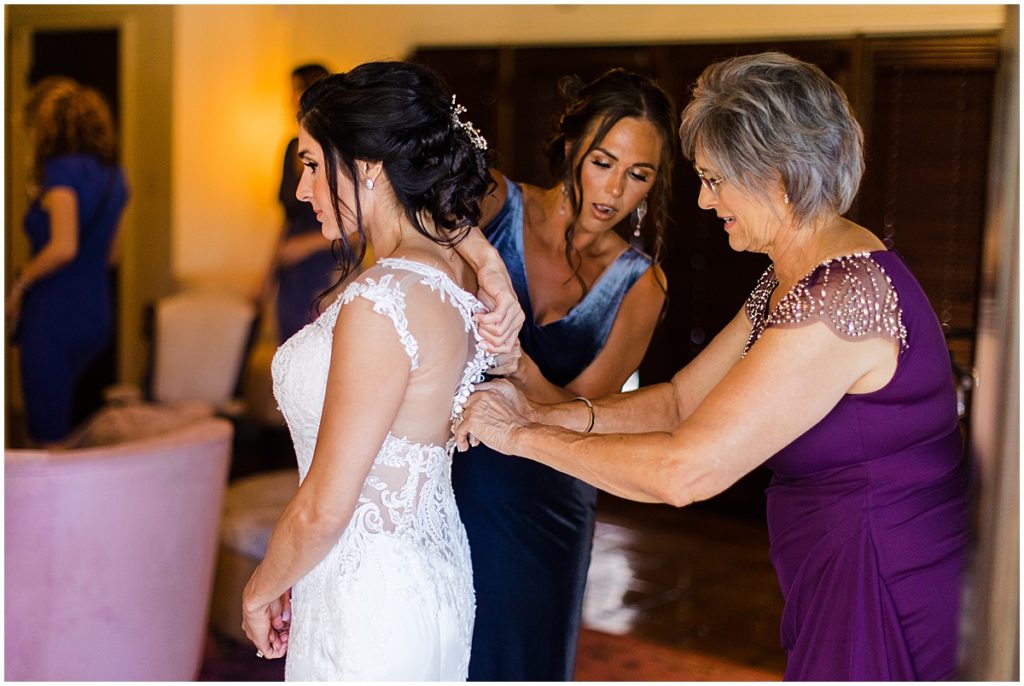 Brides getting wedding dress on at The Vineyards and Chappel Lodge in Austin Texas.