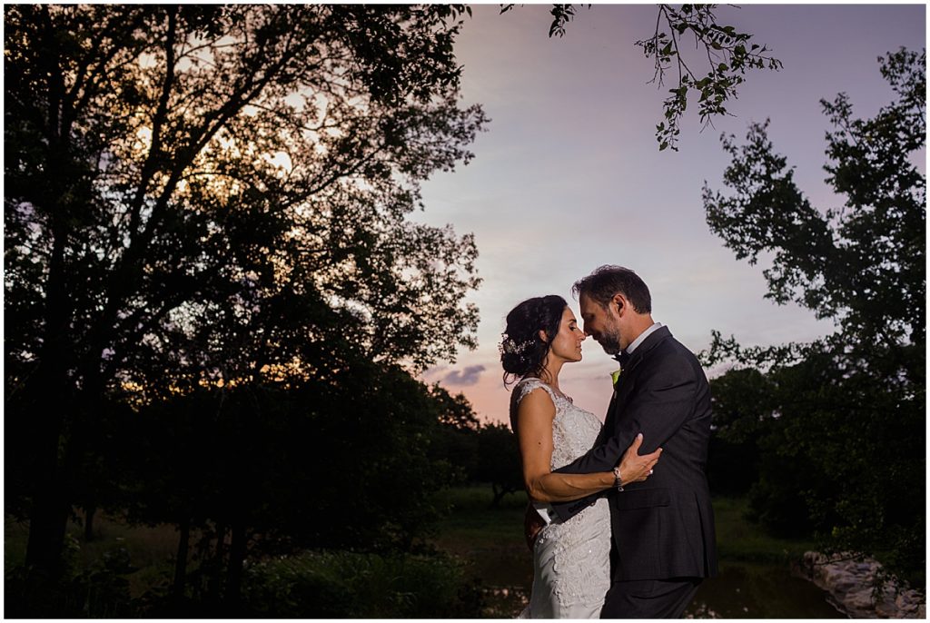 Bride and groom outside in the evening at The Vineyards at Chappel Lodge.