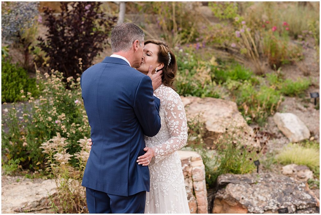 Bride and groom kissing at Betty Ford Alpine Gardens in Vail for micro wedding.