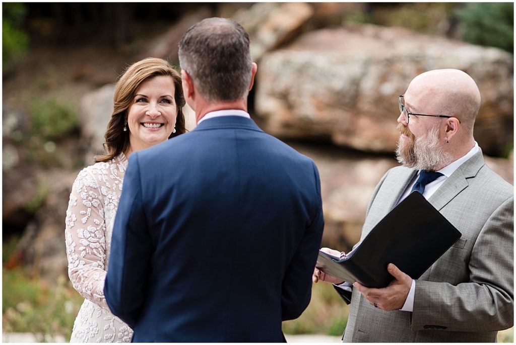 Bride laughing with groom during ceremony at Betty Ford Alpine Gardens in Vail for micro wedding.  