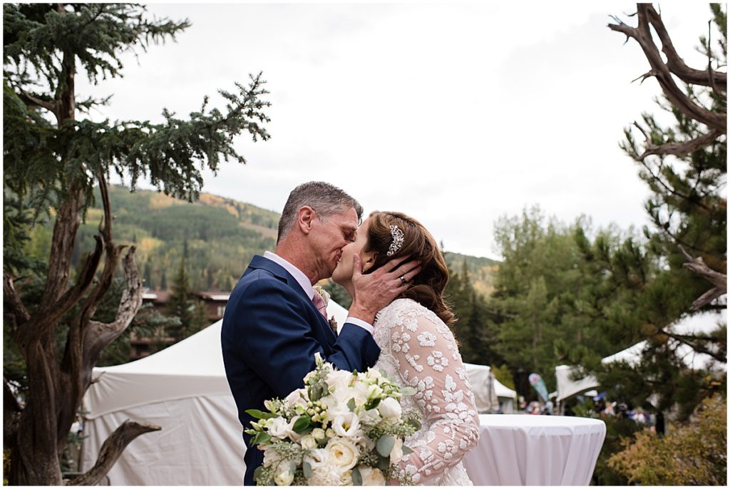 Bride and groom kissing after ceremony at Betty Ford Alpine Gardens in Vail for micro wedding.  
