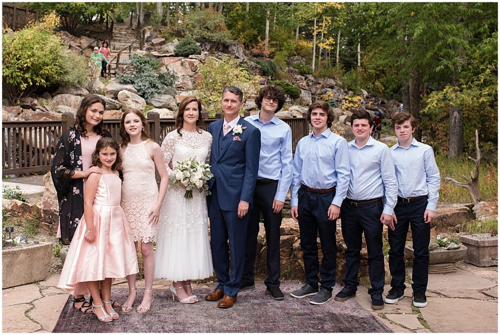 Bride and groom with kids after ceremony at Betty Ford Alpine Gardens in Vail for micro wedding.  