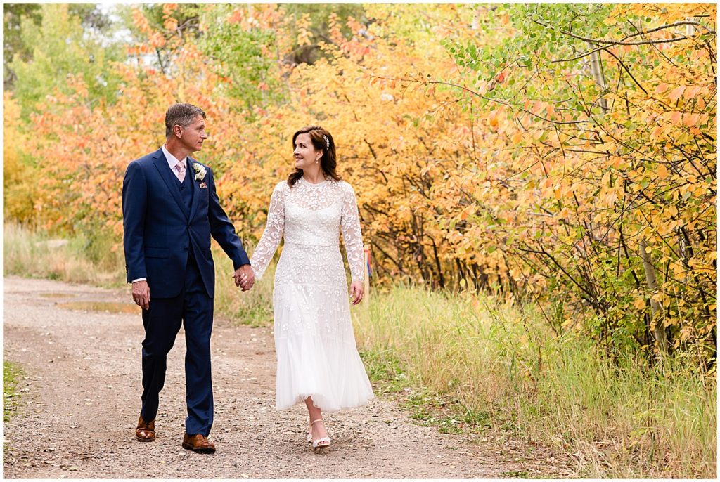 Bride and groom walking down trail at Betty Ford Alpine Gardens in Vail.  