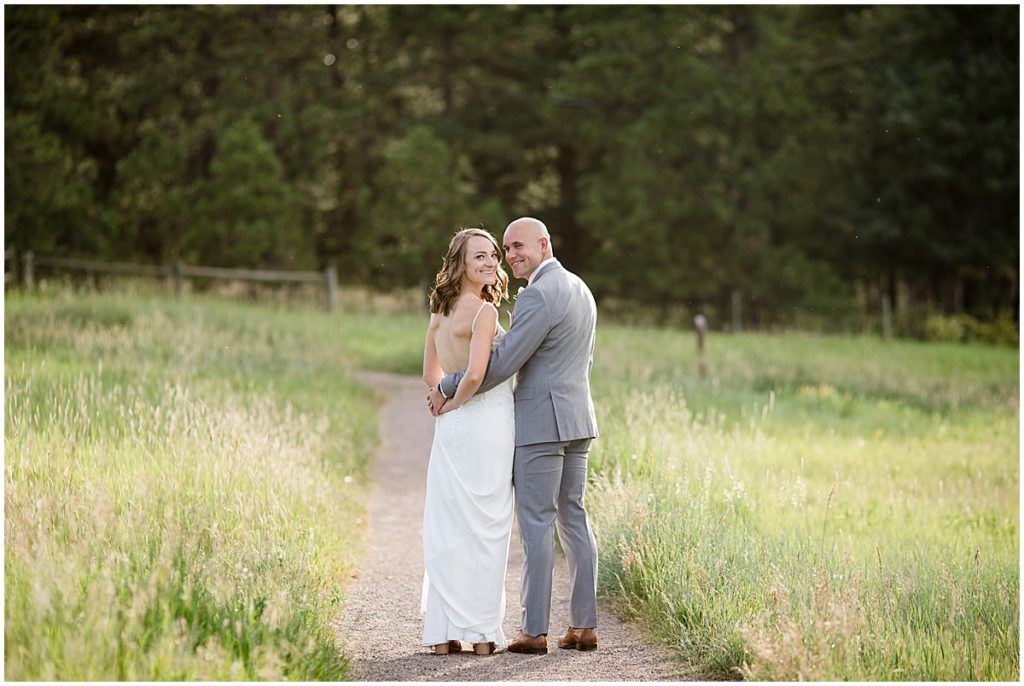 Bride and groom walking before elopement at Three Sisters Park in Evergreen