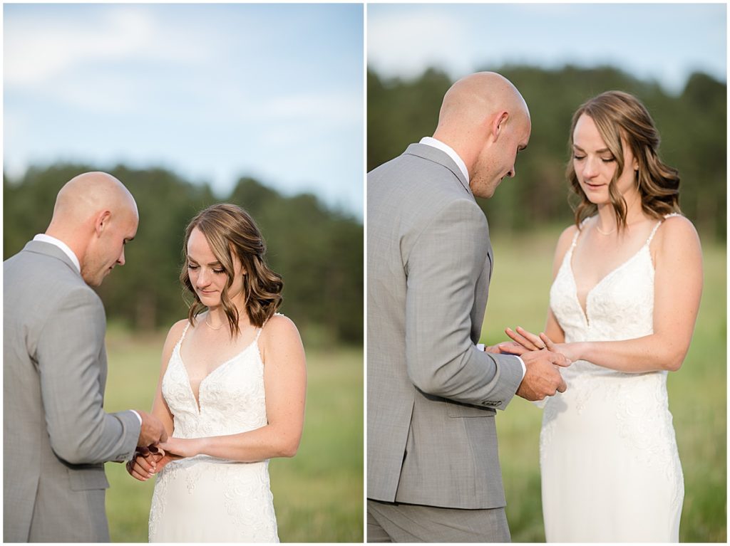 Groom putting ring on bride's finger outside during elopement at Three Sisters Park in Evergreen