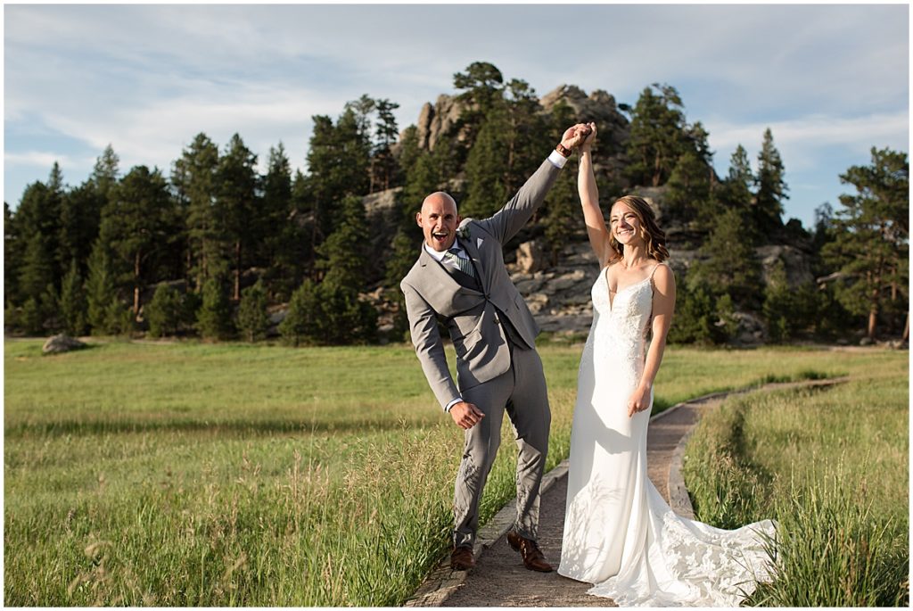 Bride and groom holding hands celebrating elopement at Three Sisters Park in Evergreen