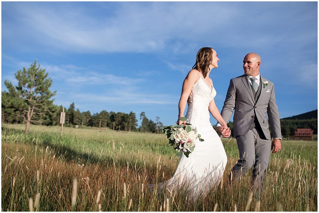 Bride and groom walking outside after elopement at Three Sisters Park in Evergreen