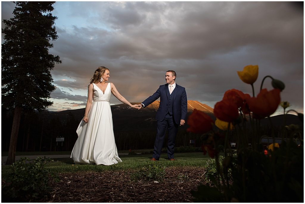 Bride and groom outside at 10 Mile Station in Breckenridge during the evening