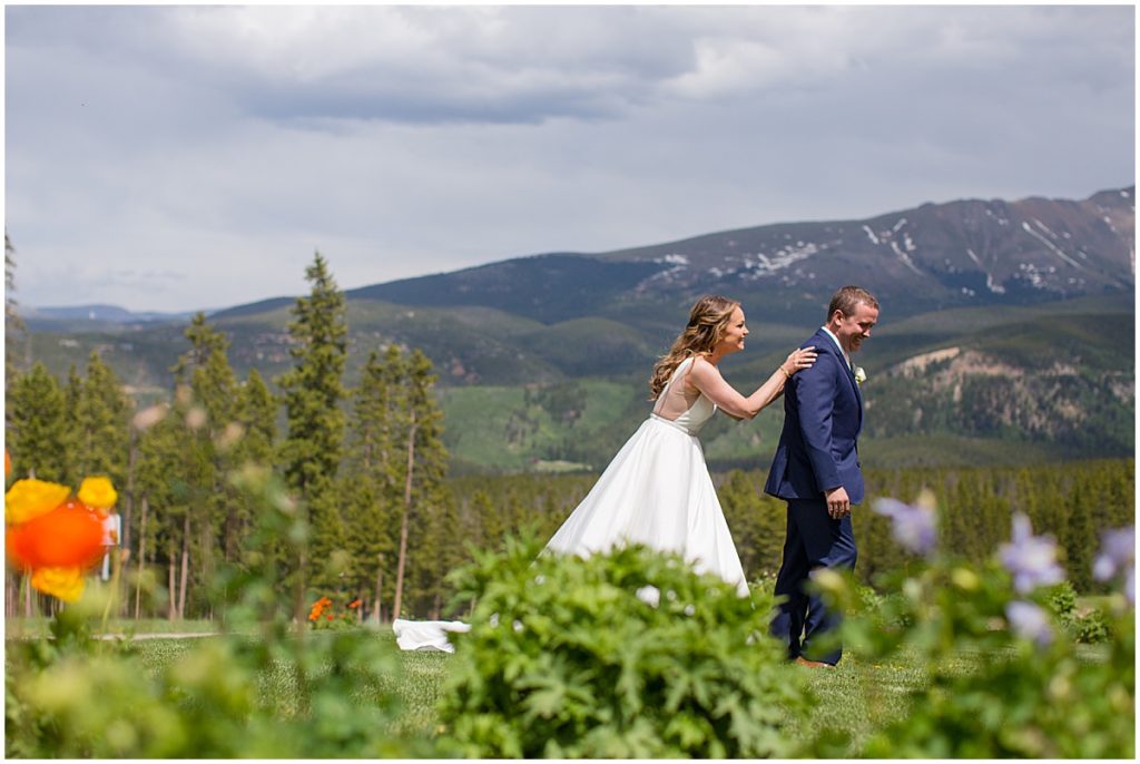 Bride tapping shoulder of groom for surprise first look at 10 mile station in Breckenridge