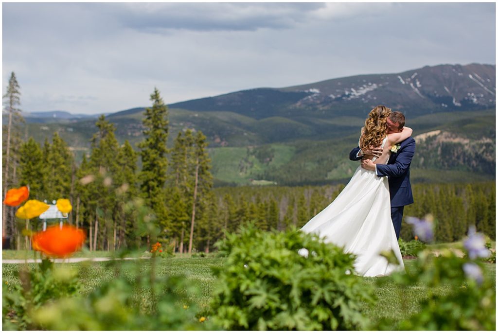 Bride and groom hug during first look before wedding at 10 mile station in Breckenridge