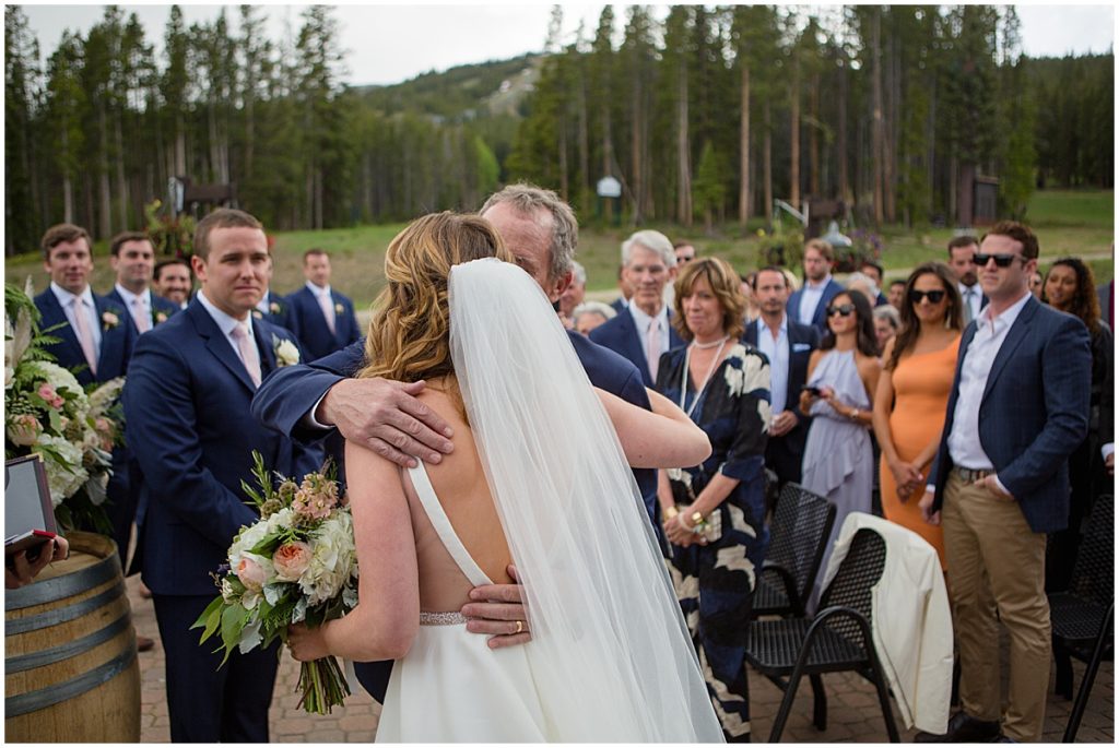 Dad and daughter hug before wedding at 10 mile station in Breckenridge
