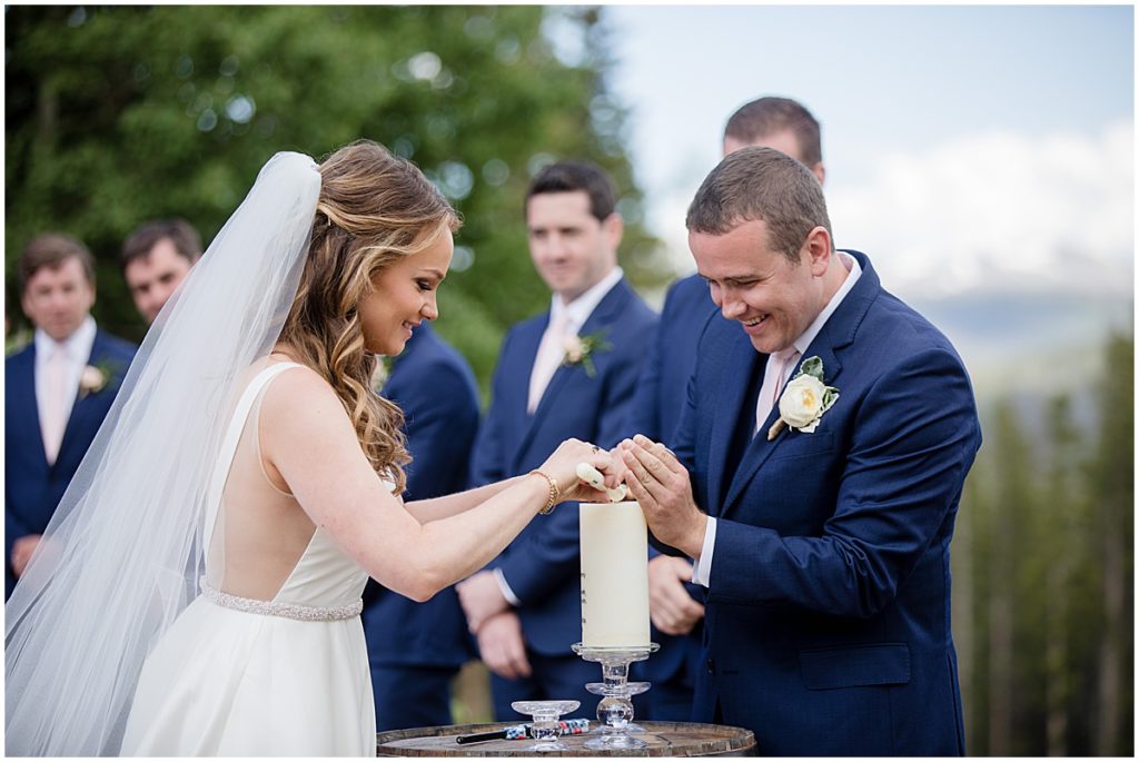Bride and groom lighting up candle for ceremony at 10 mile station in Breckenridge 