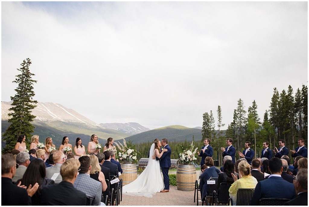 Bride and groom kiss at end of ceremony at 10 mile station in Breckenridge