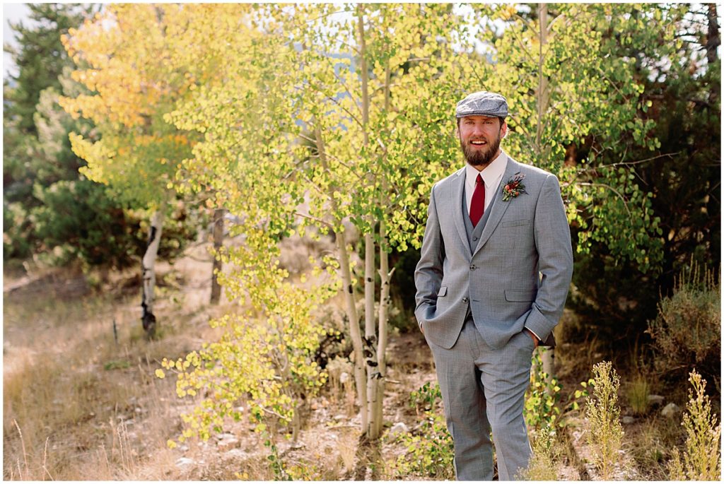 Groom wearing suit from Jim's Formal Wear for wedding at Frisco Day Lodge