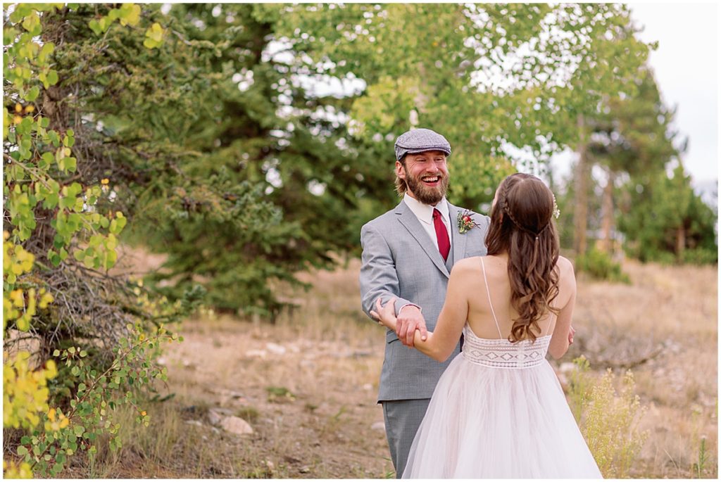 Bride and groom hold hands for first look at Frisco Day Lodge