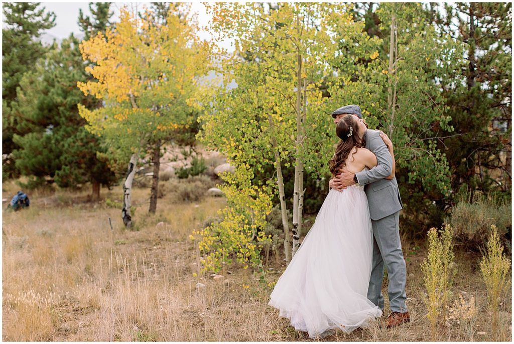 Bride and groom hugging for first look at Frisco Day Lodge