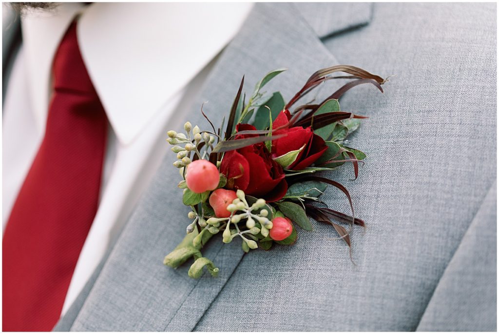 Groom's boutonniere designed by Garden of Eden Flowers and Gifts