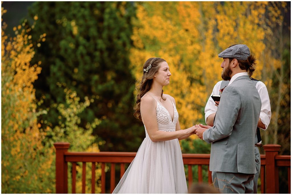 Bride and groom looking at each other during wedding ceremony at Frisco Day Lodge