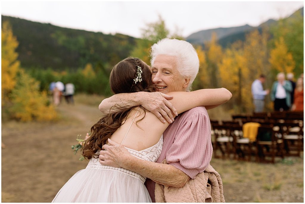 Bride hugging grandma at the end of wedding ceremony at Frisco Day Lodge