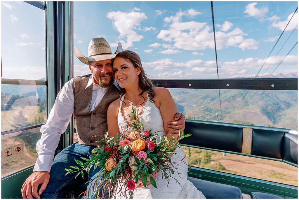 Bride holding bouquet designed by Garden of Eden going on gondola at The Holy Cross Overlook in Vail