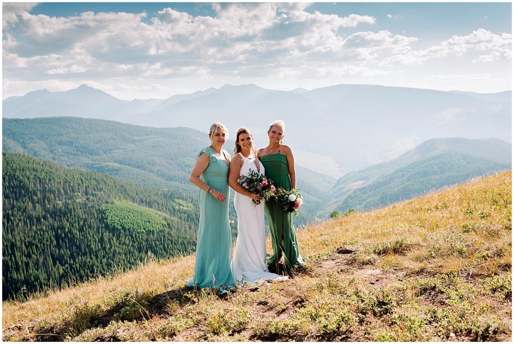Bride and with bridesmaids at top of The Holy Cross Overlook in Vail