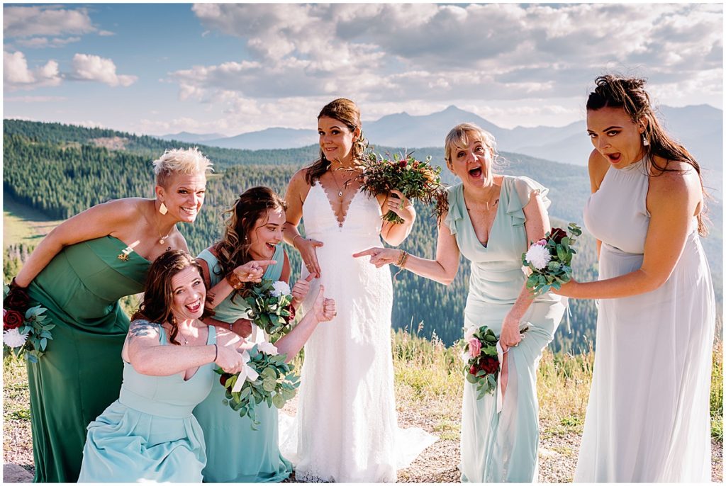 Bridesmaids pointing to the ring on bride's finger before ceremony in Vail