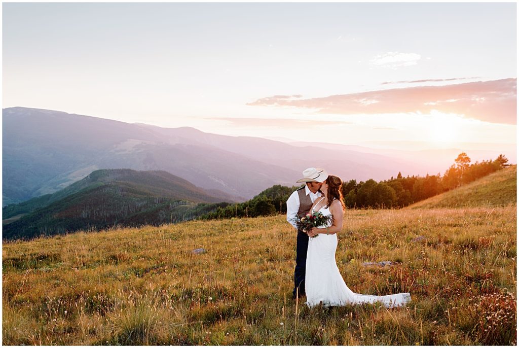 Bride and groom kissing at Holy Cross Overlook in Vail