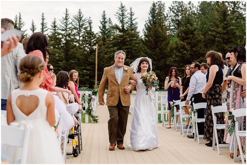 Father walking down daughter for ceremony at Deer Creek Valley Ranch wedding