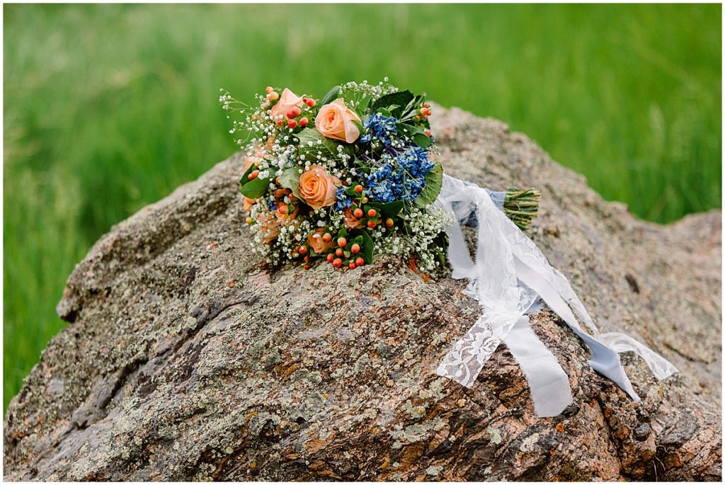 Bride’s bouquet on rock at Deer Creek Valley Ranch
