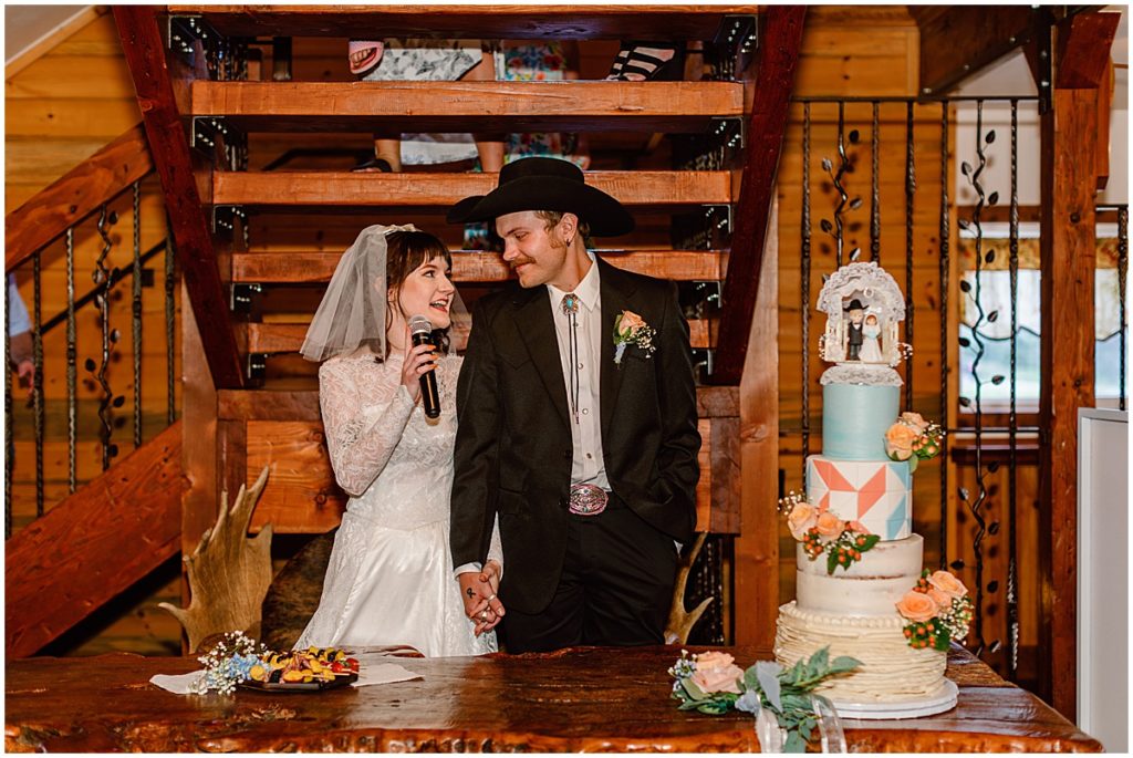 Bride and groom giving speech in barn at Deer Creek Valley Ranch