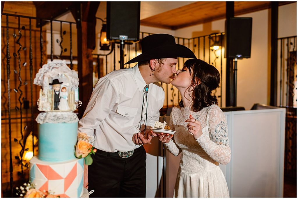 Bride and groom sharing wedding cake by Swede Ride Bake Shop at Deer Creek Valley Ranch