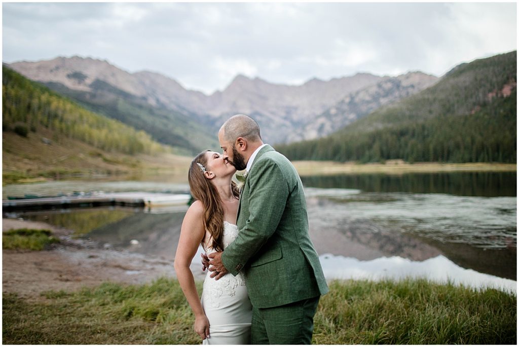 Bride and groom walking by Piney Lake at Piney River Ranch in Vail