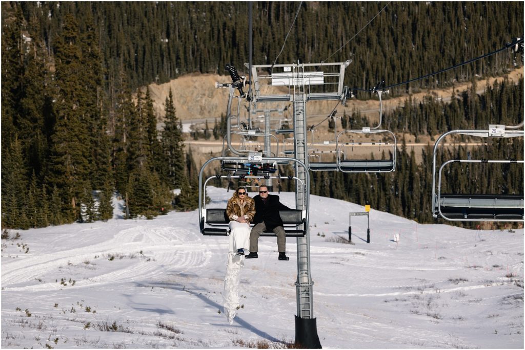 Bride and father riding chairlift at Arapahoe Basin