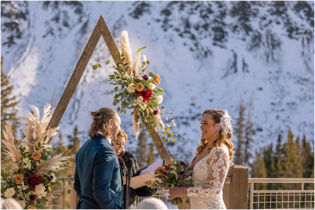 Wedding ceremony outside at Arapahoe Basin.  Floral decor by Plum Sage Flowers.