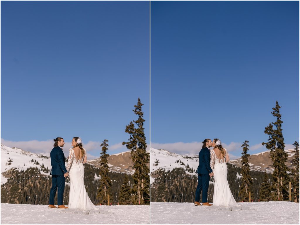 Bride and groom kissing on top of mountain at Arapahoe Basin
