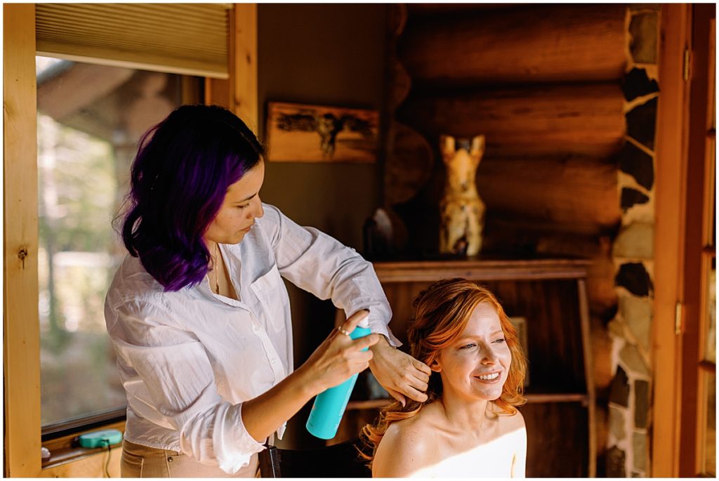 Bride getting hair done by Dulce Diem and makeup by Taylor Olson for Fall wedding at Blue Sky Mountain Ranch in Blackhawk.