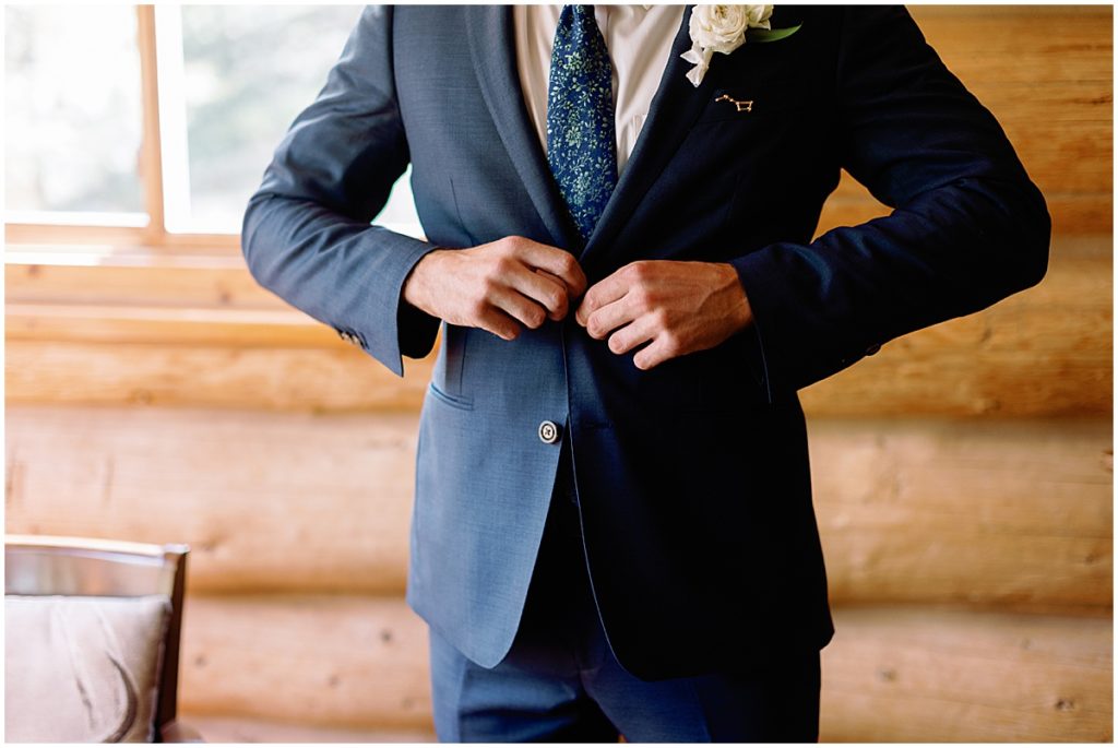 Groom wearing suit from Indochino getting ready for Fall elopement at Blue Sky Mountain Ranch in Black Hawk.