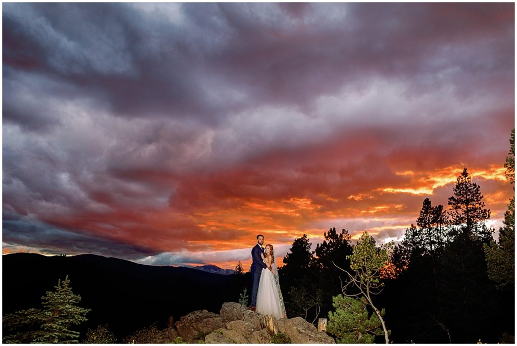 Evening fall elopement ceremony at Blue Sky Mountain Ranch in Blackhawk with bride wearing dress from BHLDN and designed by Watters.  Groom is wearing suit from Indochino. 