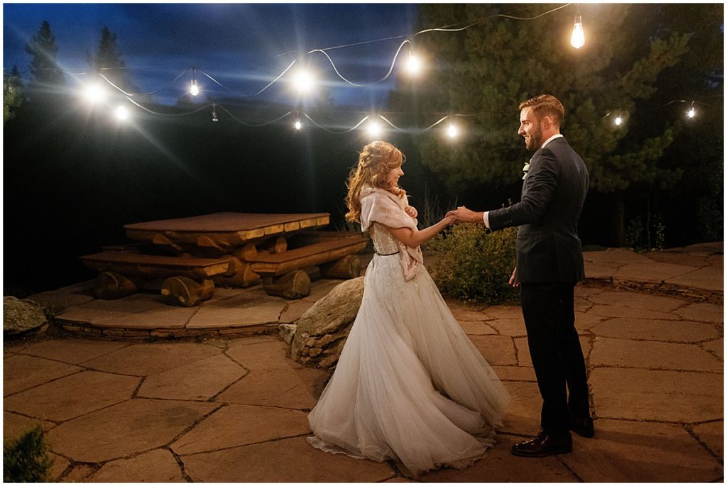 Evening first dance elopement ceremony at Blue Sky Mountain Ranch in Blackhawk with bride wearing dress from BHLDN and designed by Watters.  Groom is wearing suit from Indochino. 