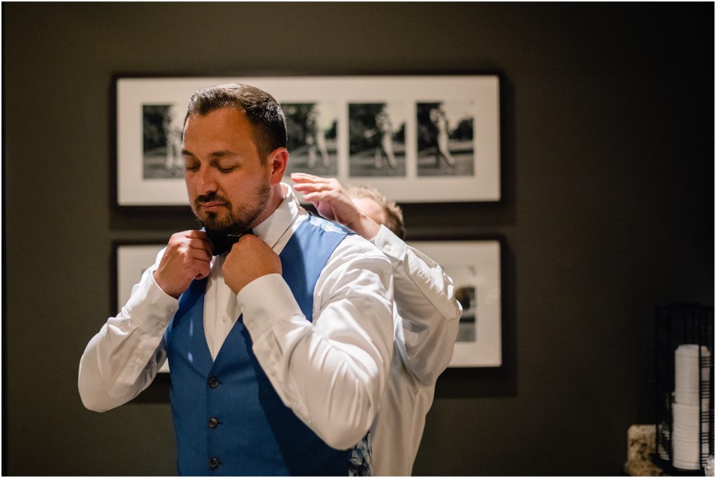 Groom getting ready at Columbine Country Club for wedding