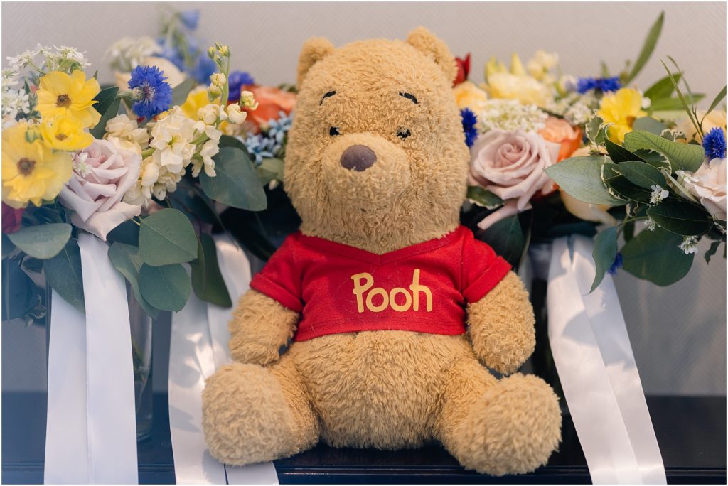 Winnie the Phooh stuffed doll with floral design by Prive Events for wedding at Columbine Country Club